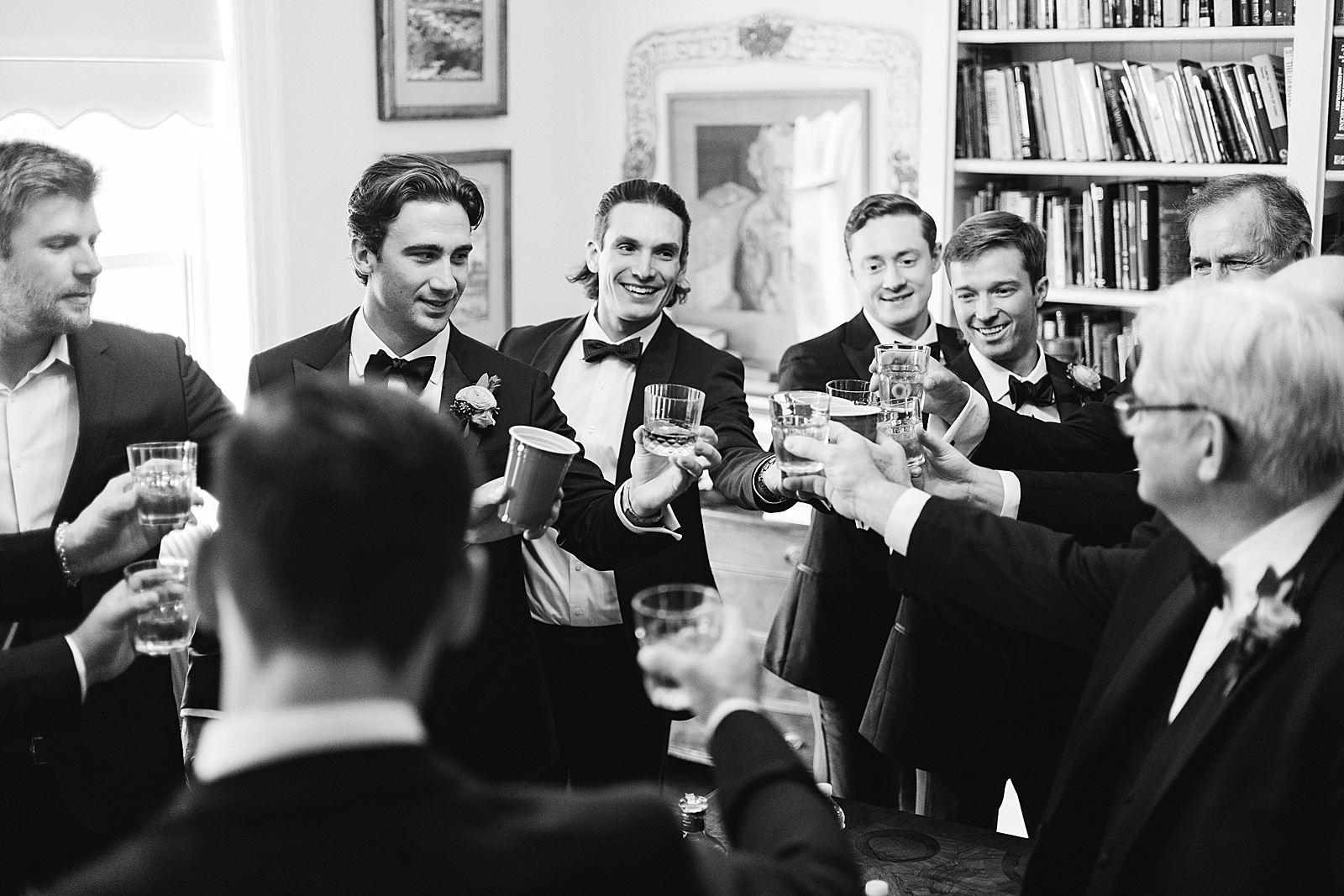 groomsmen cheers with scotch before wedding ceremony