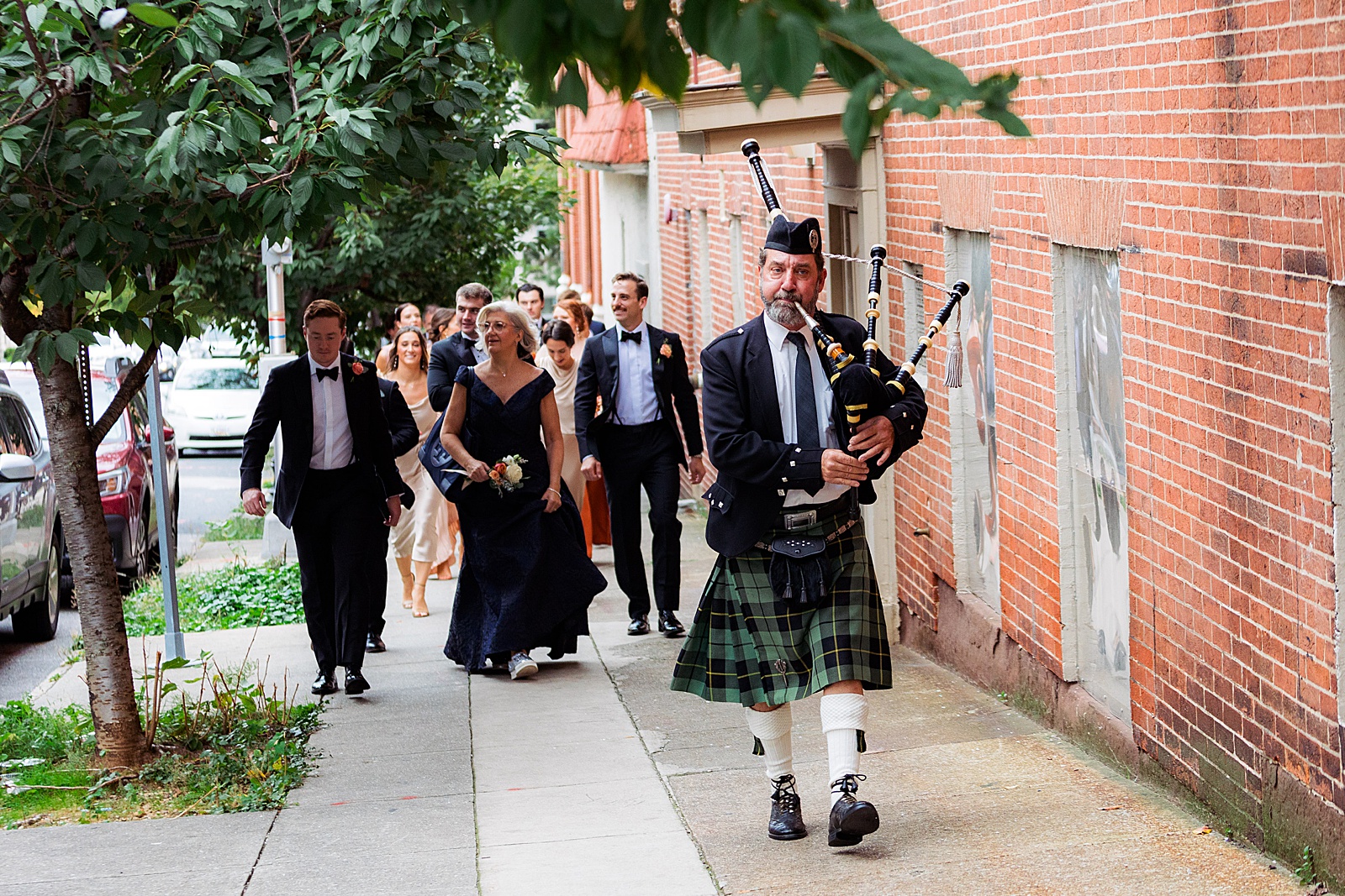 Bagpiper leads wedding guests from church to reception