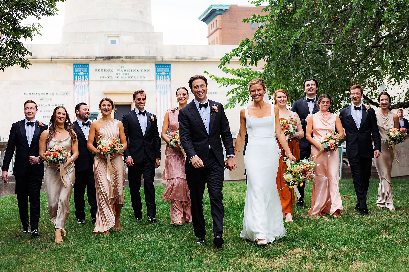 Bride and groom walk with wedding party through Baltimore's Mount Vernon