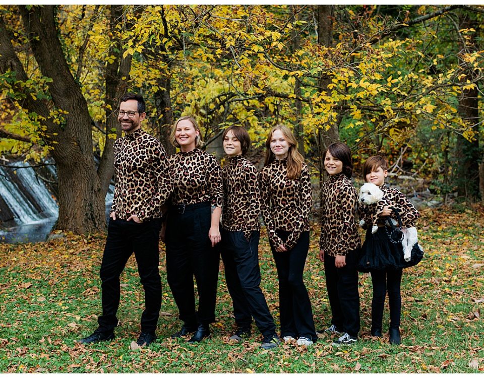 Family recreates an awkward family photo with everyone standing in a line and wearing matching leopard turtlenecks.