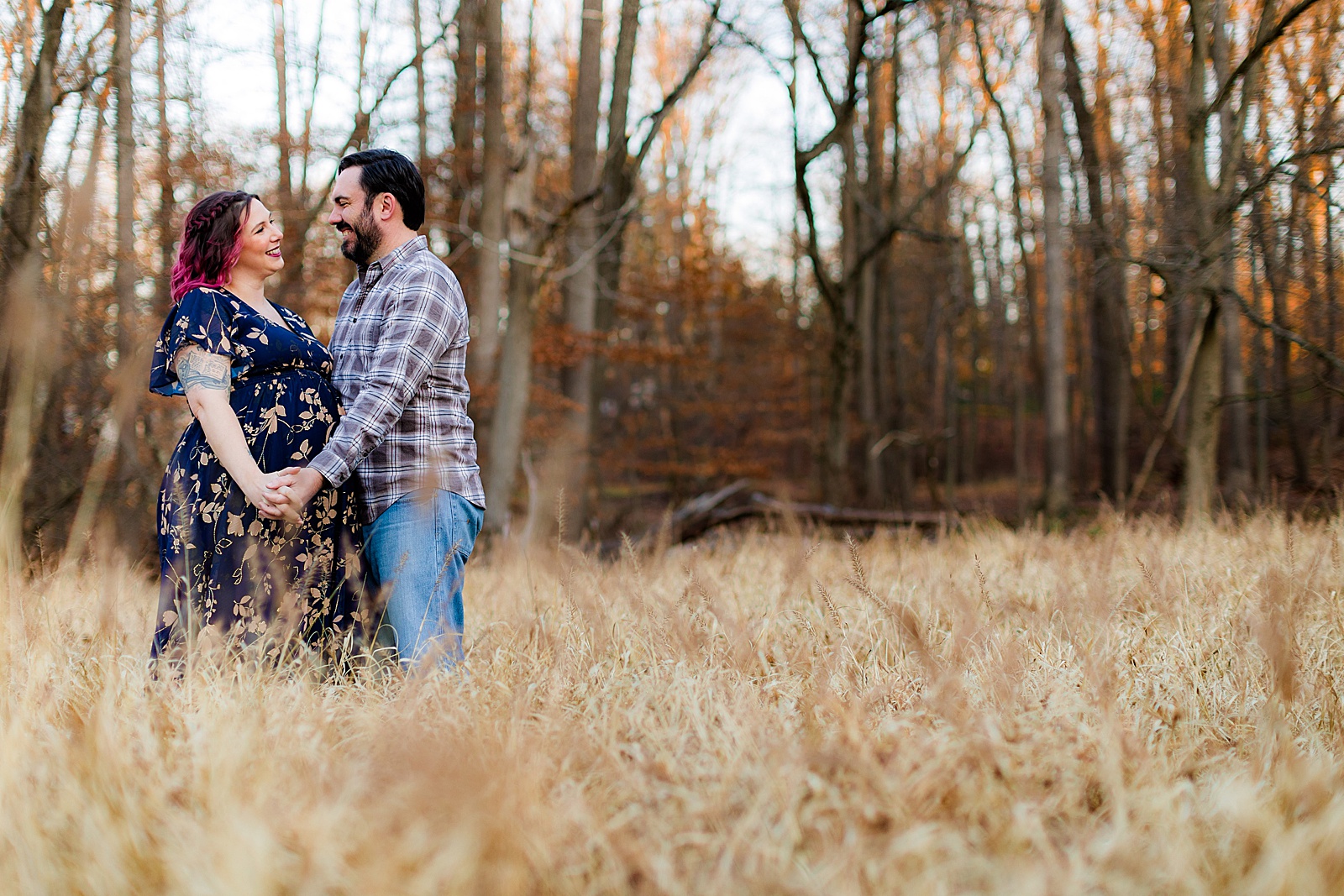 Couple gazes lovingly into each other eyes in an outdoor nature location in Maryland. 