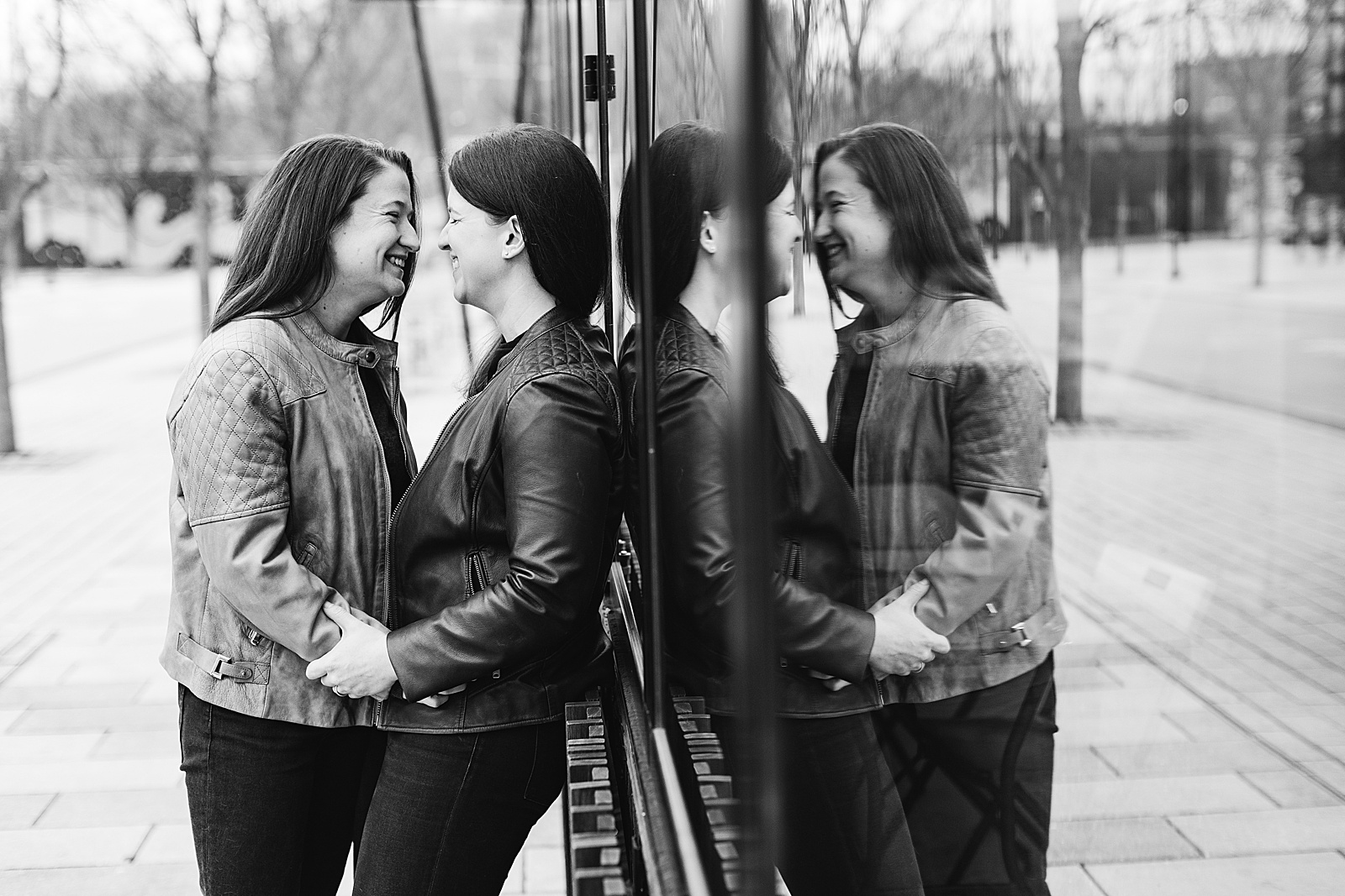 LGBTQ couple is reflected in the glass in this neighborhood DC engagement session.