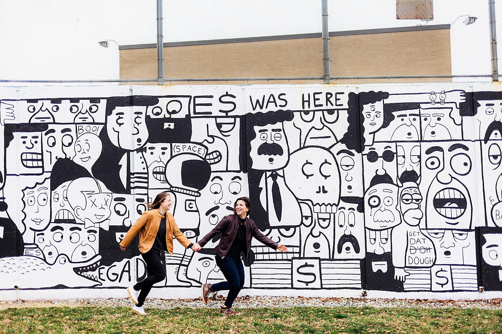 Engagement photos in front of a black and white mural in Eckington. 