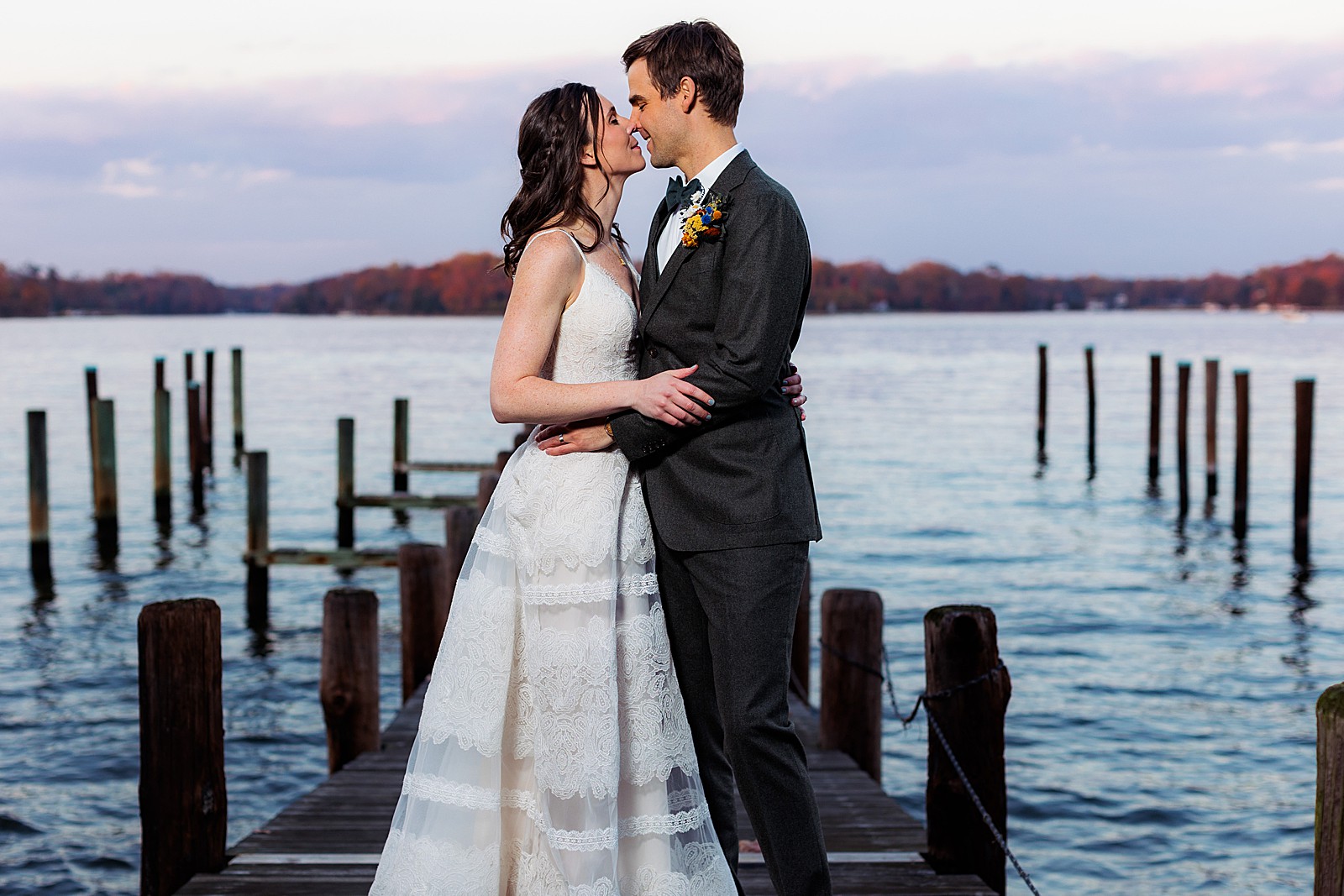 Bride and groom share a romantic moment during sunset on the dock at Historic London Town and Gardens. 