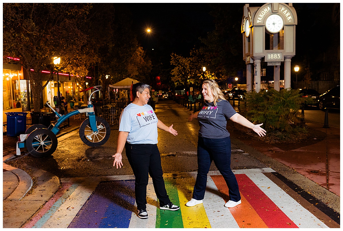 LGBTQ couple in downtown Takoma Park engagement photos stands on a rainbow walkway