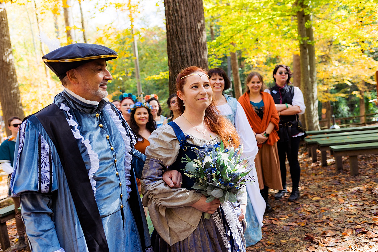 Father of the bride walks his daughter down the aisle at a renn faire wedding. 