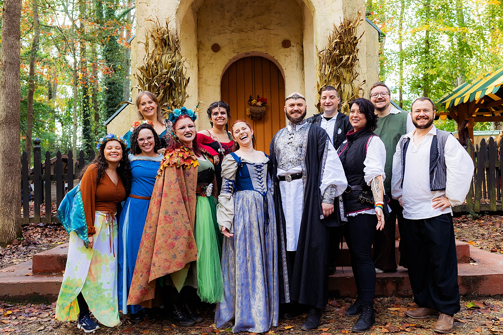 Bride and groom and friends gather in costume for a photo at a MD Renaissance wedding.