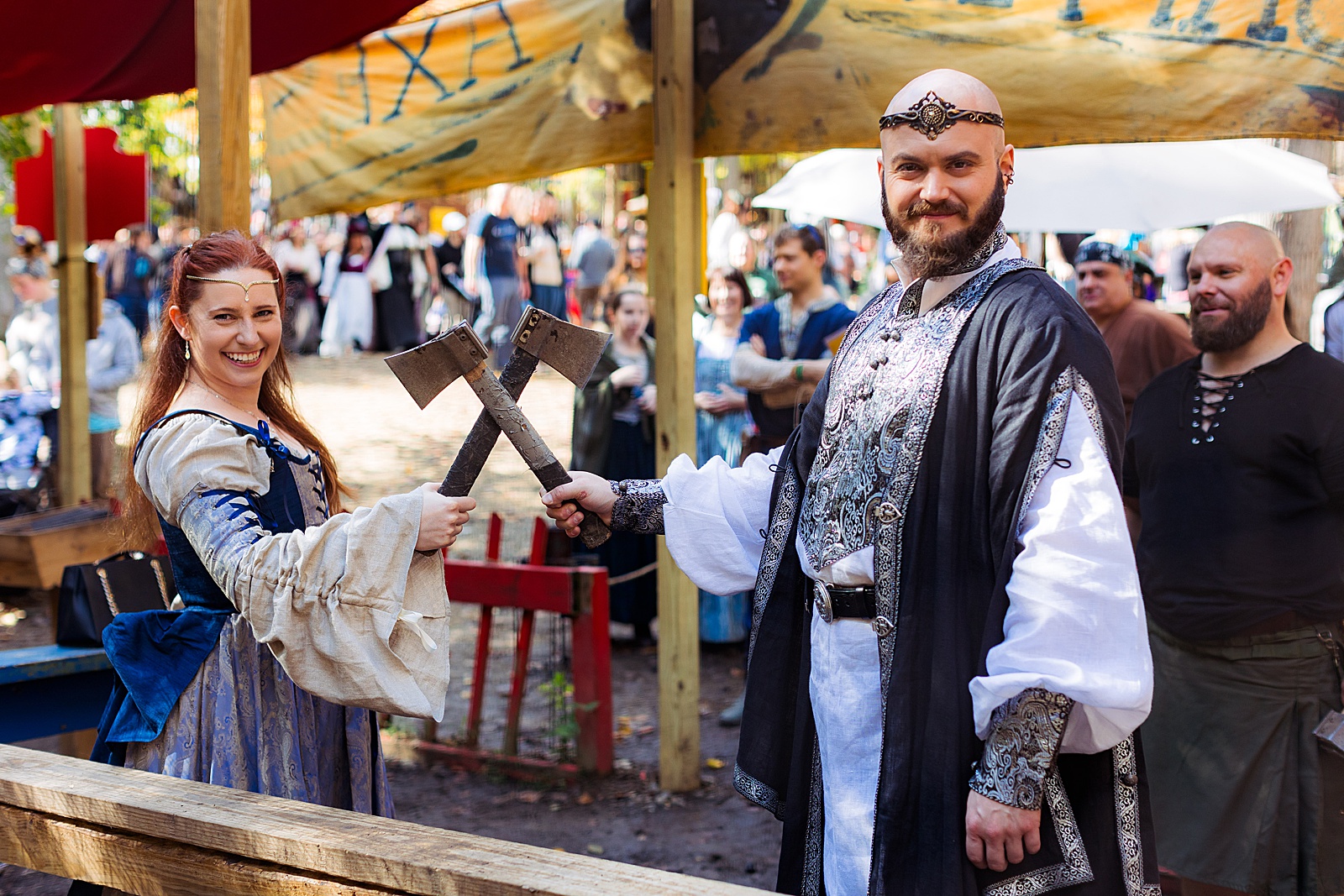 Bride and groom prepare to throw battle axes at their MD Renn Fest wedding.