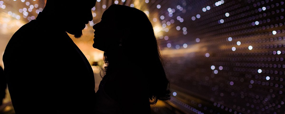 A couple is silhouetted by the lights of the Multiverse light installation at the National Gallery of Art in DC.
