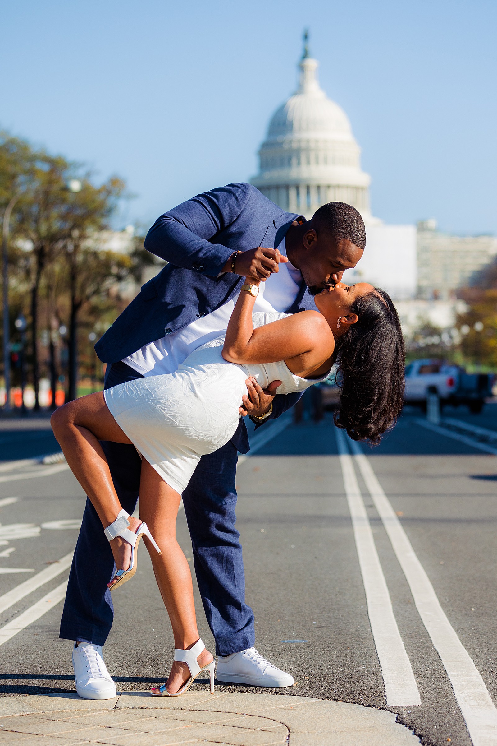 Engaged couple practices their dip with the US Capitol in the background.