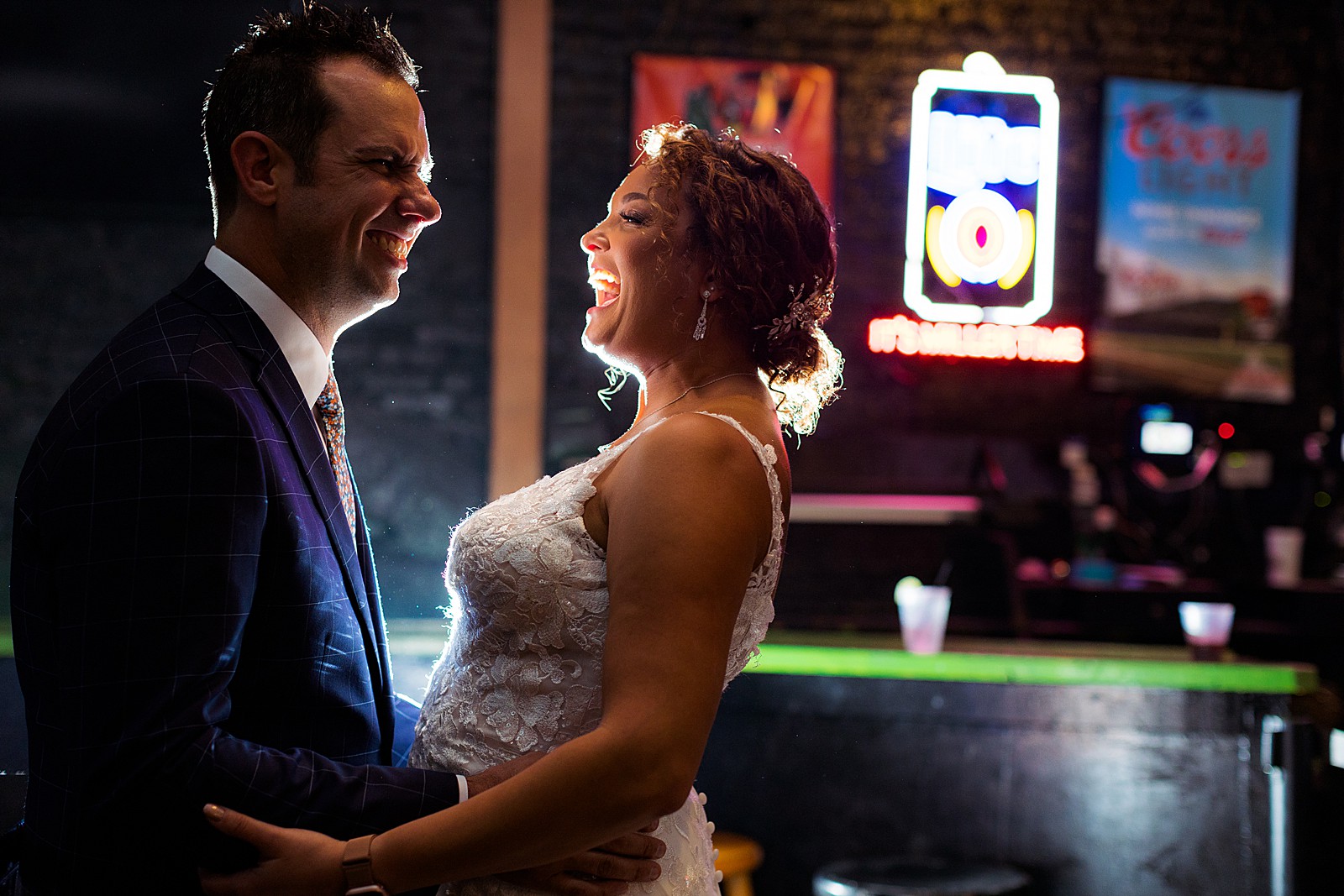 The bride and groom do portraits at Pickles Pub in Baltimore before their rainy day AVAM wedding. 
