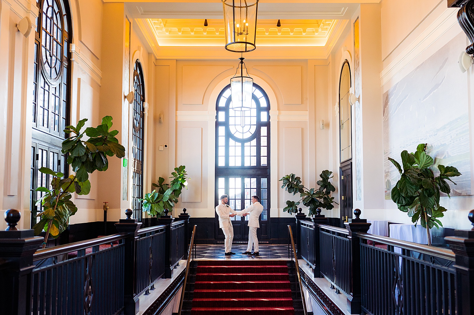Two grooms dance in the hallway of the Sagamore Pendry in Baltimore to illustrate that you can have fun while taking wedding photos! "Will I have fun?" is one of my top questions to ask your wedding photographer before booking.
