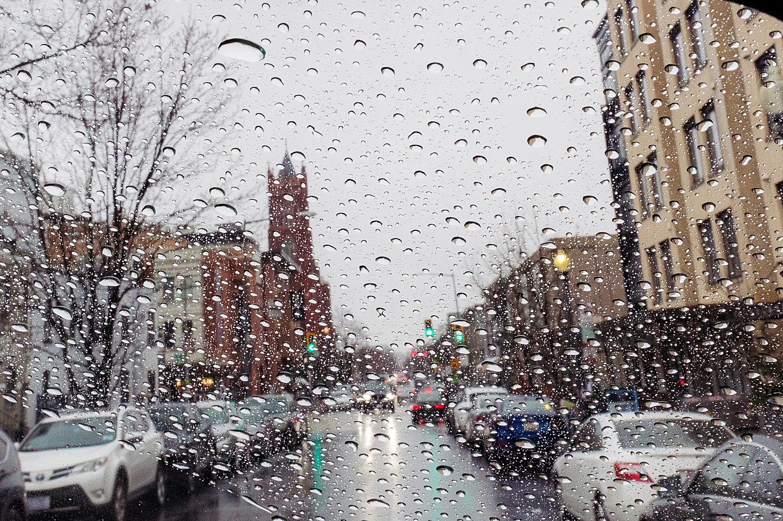 The church of the Immaculate Conception in DC is visible through raindrops on the windshield.