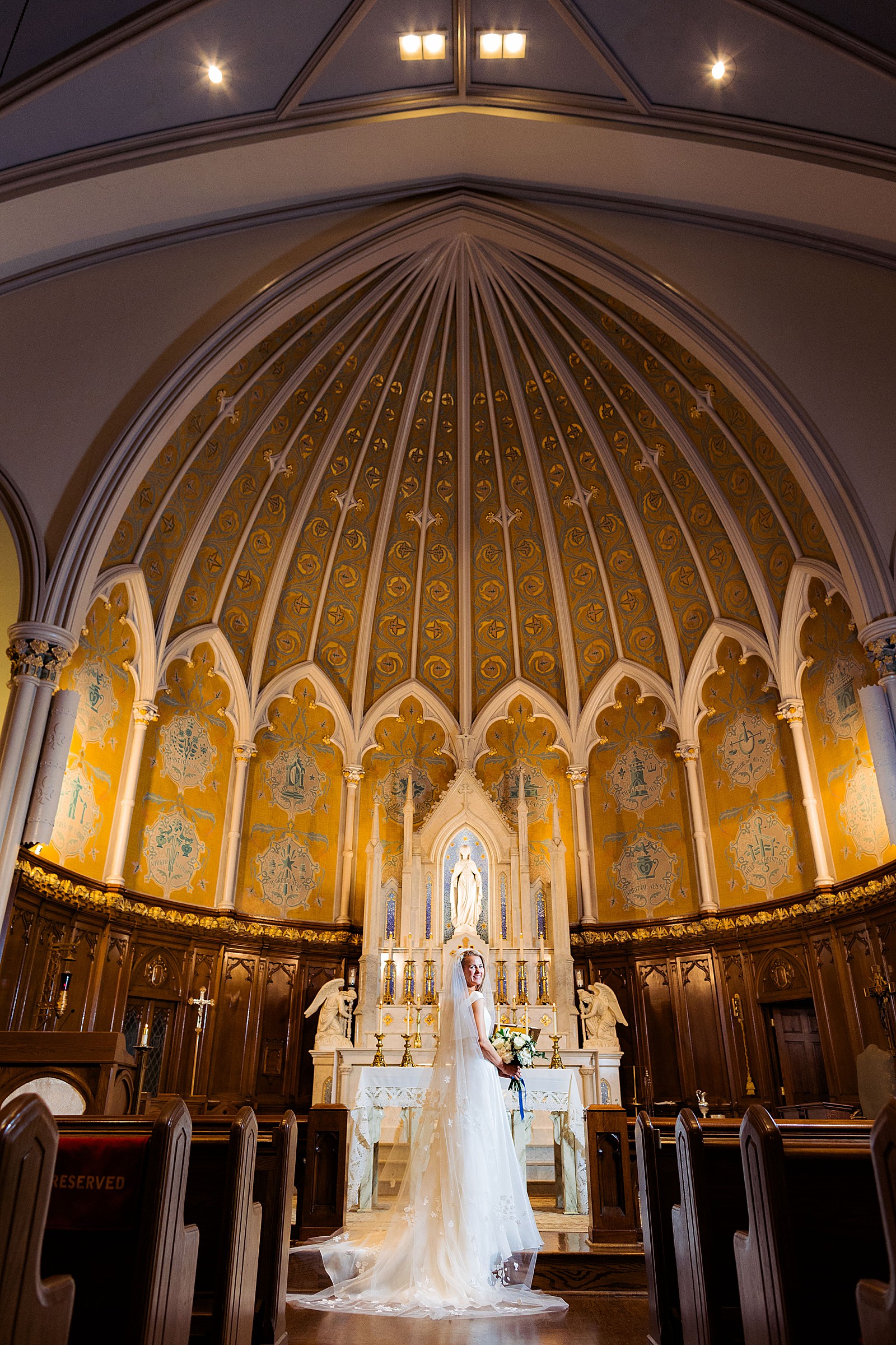 Bride poses at the church alter at Immaculate Conception Church in DC.