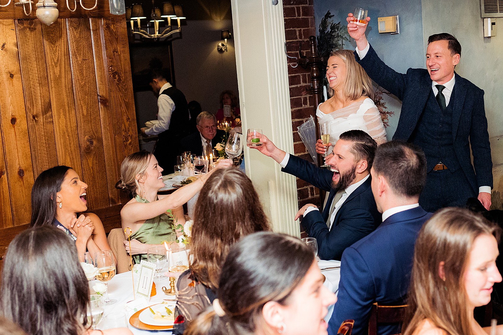 Bride and groom go around to tables to greet their guests at their rainy Mount Vernon Inn Restaurant wedding.